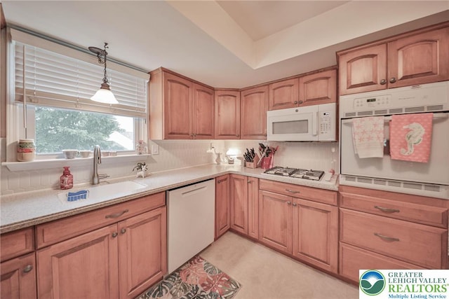1812 Treeline Dr, Forks Twp, PA 18040 - kitchen with white appliances, light countertops, pendant lighting, decorative backsplash, and brown cabinetry