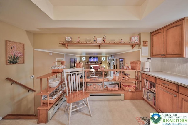 1812 Treeline Dr, Forks Twp, PA 18040 - kitchen featuring a baseboard radiator, a tray ceiling, and brown cabinets