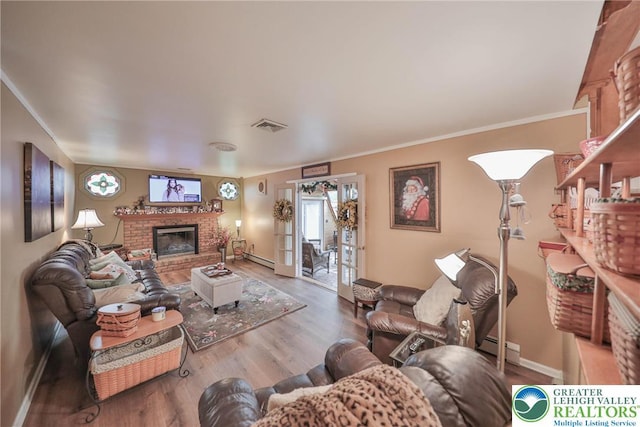 1812 Treeline Dr, Forks Twp, PA 18040 - living area featuring a fireplace, wood finished floors, ornamental molding, and a baseboard radiator