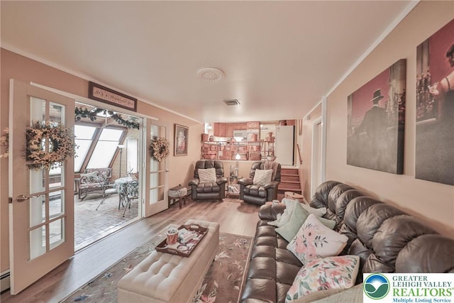 1812 Treeline Dr, Forks Twp, PA 18040 - living area featuring french doors, wood finished floors, crown molding, and a baseboard heating unit