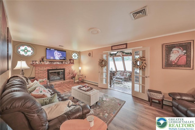 1812 Treeline Dr, Forks Twp, PA 18040 - living area featuring wood finished floors, ornamental molding, a baseboard radiator, and a fireplace