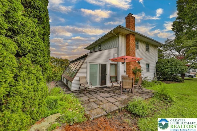 1812 Treeline Dr, Forks Twp, PA 18040 - back of property featuring a chimney, a patio area, and a yard