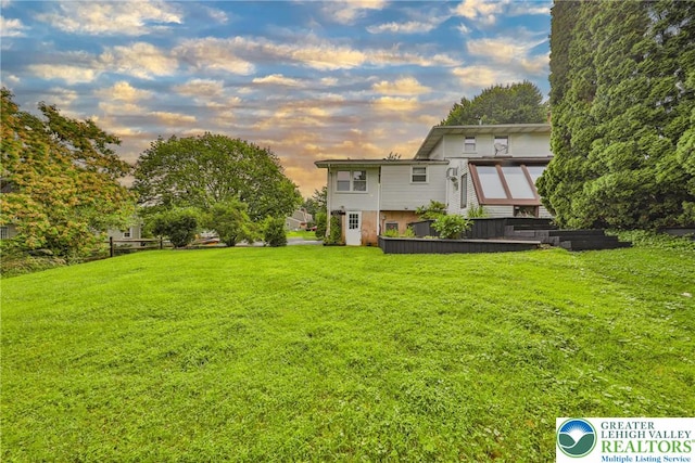 1812 Treeline Dr, Forks Twp, PA 18040 - yard at dusk featuring a lawn and a deck