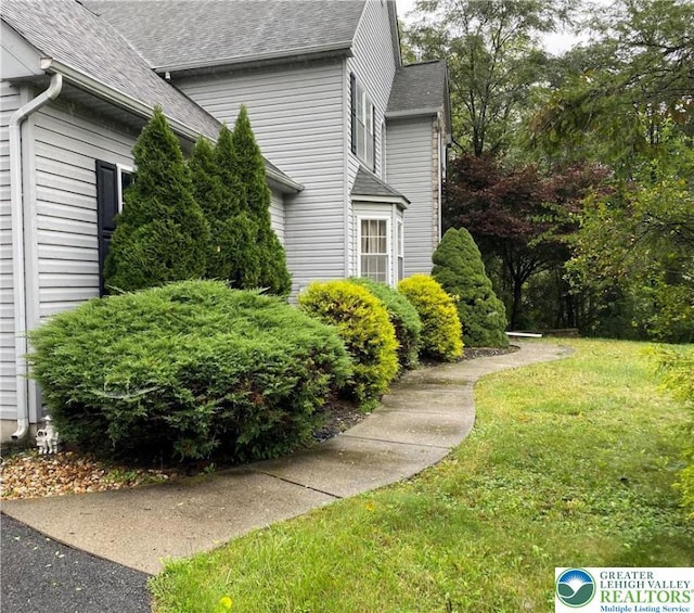 120 Palomino Cir, Washington Twp, PA 18013 - view of home's exterior featuring a shingled roof and a lawn