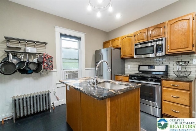 537 Seitz St, Easton, PA 18042 - kitchen with appliances with stainless steel finishes, radiator heating unit, an island with sink, backsplash, and cooling unit