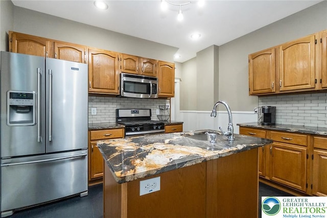 537 Seitz St, Easton, PA 18042 - kitchen with stainless steel appliances, dark stone countertops, backsplash, brown cabinetry, and an island with sink
