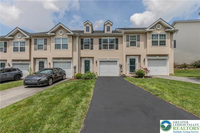 733 Trout Creek Ln, Allentown City, PA 18103 - townhome / multi-family property featuring driveway, a garage, and a front yard