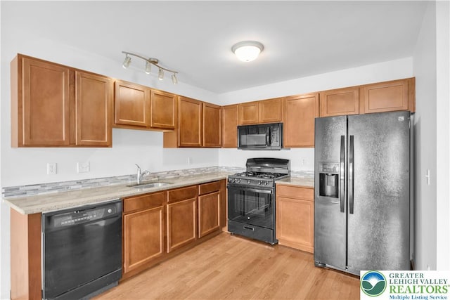 733 Trout Creek Ln, Allentown City, PA 18103 - kitchen featuring black appliances, light wood-style flooring, and brown cabinetry