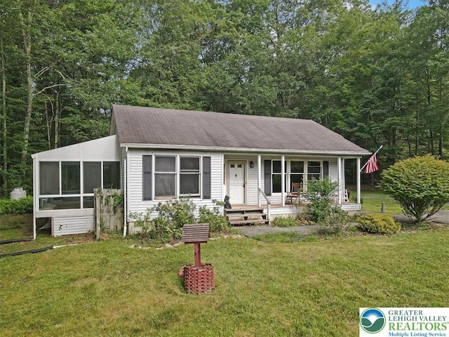 671 Dotters Corner Rd, Polk Twp, PA 18058 - view of front facade featuring a front lawn, a sunroom, covered porch, and a shingled roof