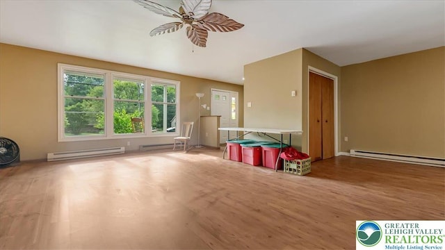 671 Dotters Corner Rd, Polk Twp, PA 18058 - unfurnished living room with baseboard heating, a ceiling fan, and wood finished floors