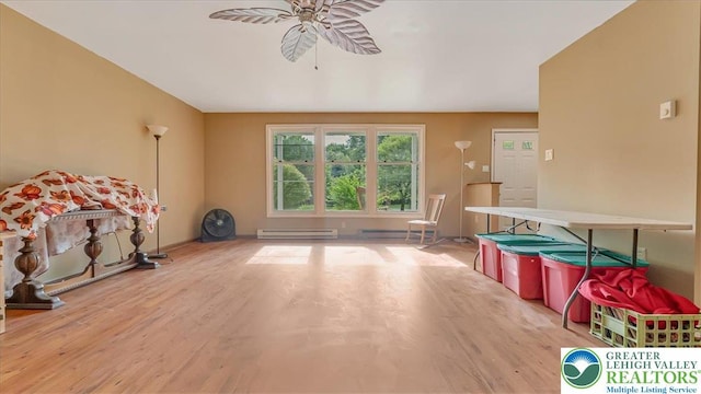 671 Dotters Corner Rd, Polk Twp, PA 18058 - recreation room with a baseboard heating unit, ceiling fan, wood finished floors, and a baseboard radiator