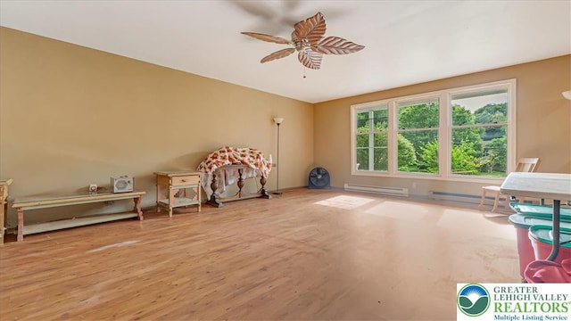 671 Dotters Corner Rd, Polk Twp, PA 18058 - playroom with a baseboard heating unit, a ceiling fan, and wood finished floors