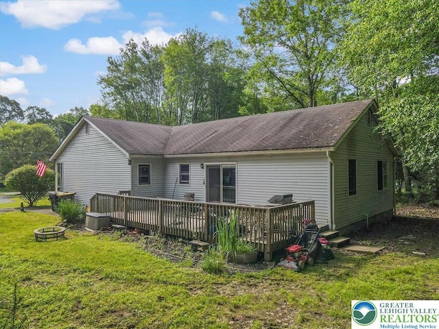 671 Dotters Corner Rd, Polk Twp, PA 18058 - rear view of property featuring a fire pit, a deck, and a lawn