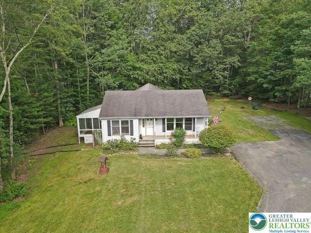 671 Dotters Corner Rd, Polk Twp, PA 18058 - view of front of property with a front lawn, a view of trees, a sunroom, and a porch