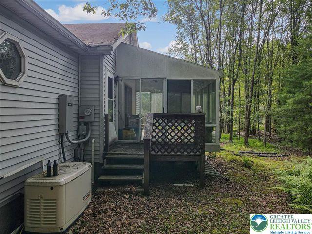671 Dotters Corner Rd, Polk Twp, PA 18058 - wooden deck featuring a sunroom