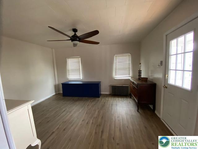 838 E Patterson St, Lansford Boro, PA 18232 - unfurnished living room featuring radiator, a ceiling fan, and wood finished floors