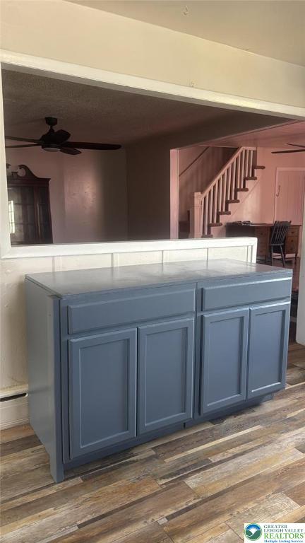 838 E Patterson St, Lansford Boro, PA 18232 - kitchen featuring a ceiling fan, blue cabinets, and wood finished floors