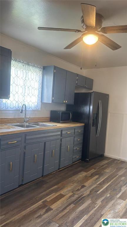 838 E Patterson St, Lansford Boro, PA 18232 - kitchen with dark wood-style flooring, gray cabinets, ceiling fan, black fridge, and light countertops