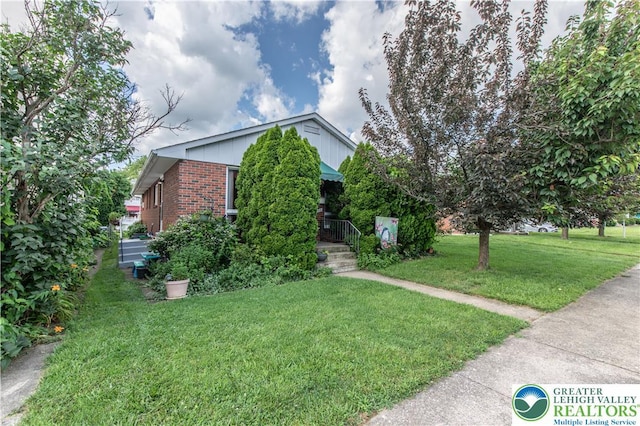 1919 W Cedar St Unit 1919, Allentown City, PA 18104 - obstructed view of property with brick siding and a front lawn