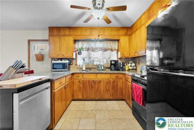 1919 W Cedar St Unit 1919, Allentown City, PA 18104 - kitchen with black appliances, a peninsula, a ceiling fan, brown cabinetry, and light tile patterned floors