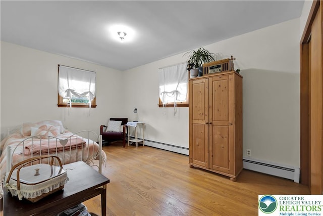 1919 W Cedar St Unit 1919, Allentown City, PA 18104 - bedroom with a baseboard radiator, multiple windows, and light wood finished floors
