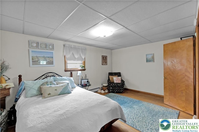 1919 W Cedar St Unit 1919, Allentown City, PA 18104 - bedroom with wood finished floors, a paneled ceiling, and a baseboard radiator