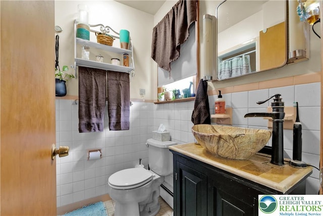 1919 W Cedar St Unit 1919, Allentown City, PA 18104 - bathroom featuring tile walls, vanity, a wainscoted wall, a baseboard radiator, and tile patterned flooring