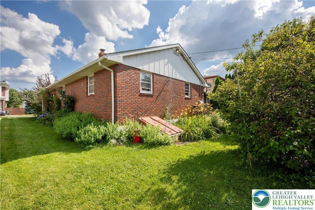 1919 W Cedar St Unit 1919, Allentown City, PA 18104 - view of property exterior featuring brick siding, a lawn, and a chimney