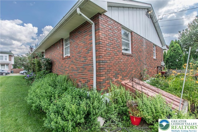 1919 W Cedar St Unit 1919, Allentown City, PA 18104 - view of side of property with brick siding, board and batten siding, and a yard