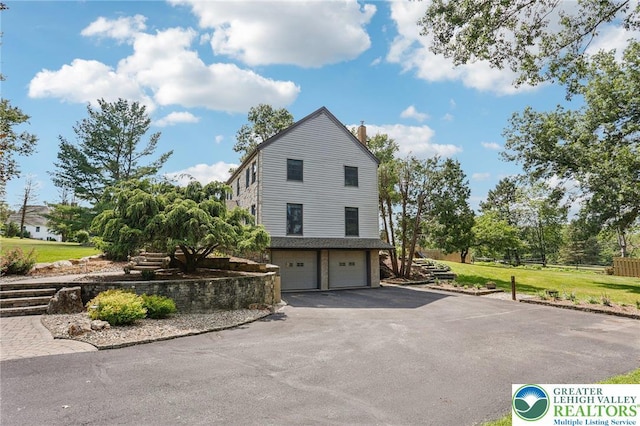6365 Constitution Rd, Lowhill Twp, PA 18078 - view of side of property with an attached garage, a chimney, and driveway