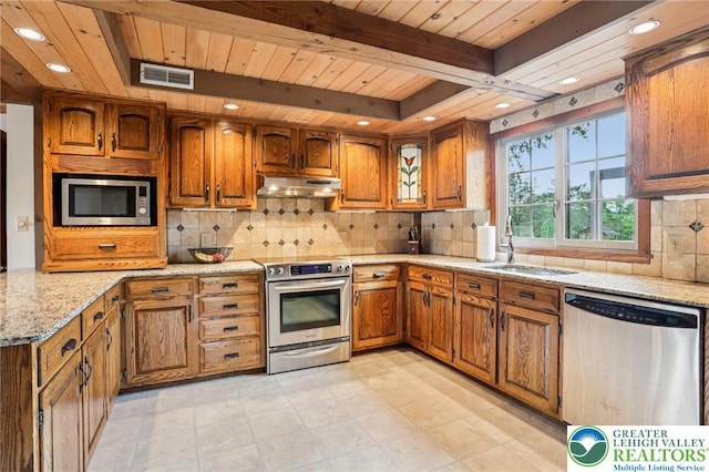 6365 Constitution Rd, Lowhill Twp, PA 18078 - kitchen with stainless steel appliances, brown cabinetry, light stone counters, a wooden ceiling with exposed beams, and tasteful backsplash