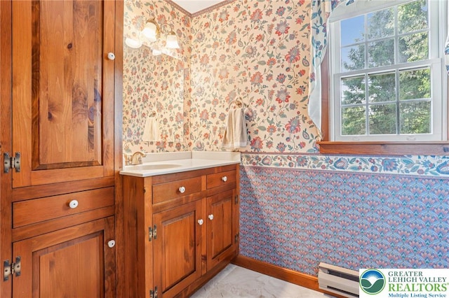 6365 Constitution Rd, Lowhill Twp, PA 18078 - bathroom with wallpapered walls, a baseboard heating unit, vanity, plenty of natural light, and a wainscoted wall