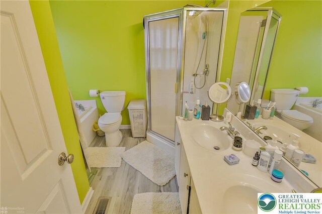 205 Maple Ct, Alburtis Boro, PA 18011 - bathroom featuring a stall shower, a bath, double vanity, and wood finished floors