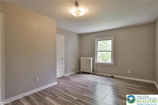 209 Cattell St, Easton, PA 18042 - empty room with radiator and wood finished floors