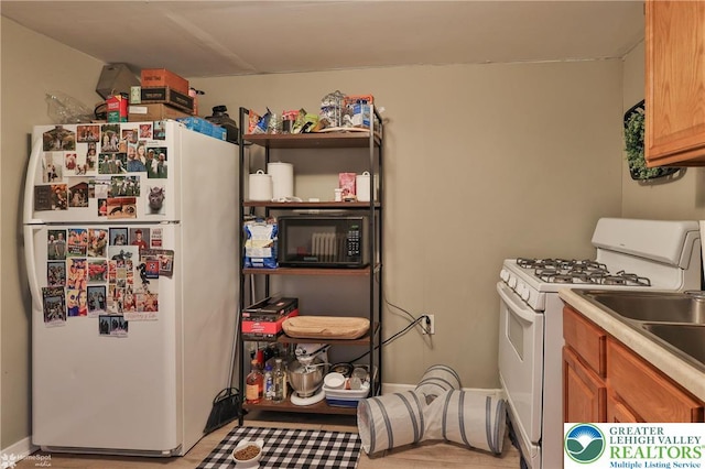 209 Cattell St, Easton, PA 18042 - kitchen with white appliances, brown cabinets, and light countertops