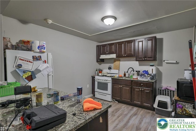 209 Cattell St, Easton, PA 18042 - kitchen with white range with gas stovetop, under cabinet range hood, dark brown cabinetry, and stone countertops
