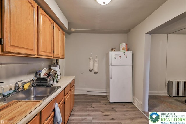 209 Cattell St, Easton, PA 18042 - kitchen featuring freestanding refrigerator, radiator, wood finished floors, and light countertops