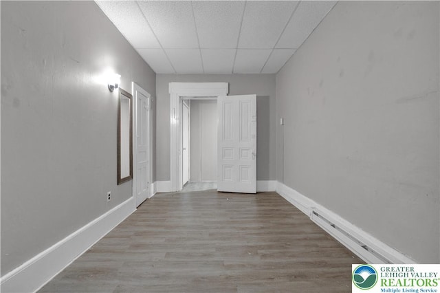 409 Broad St Unit 409, Tamaqua Boro, PA 18252 - unfurnished bedroom with a drop ceiling, wood finished floors, and a baseboard heating unit