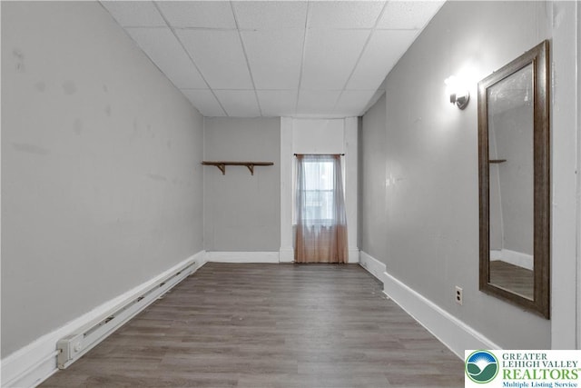 409 Broad St Unit 409, Tamaqua Boro, PA 18252 - unfurnished room with a paneled ceiling, wood finished floors, and a baseboard heating unit