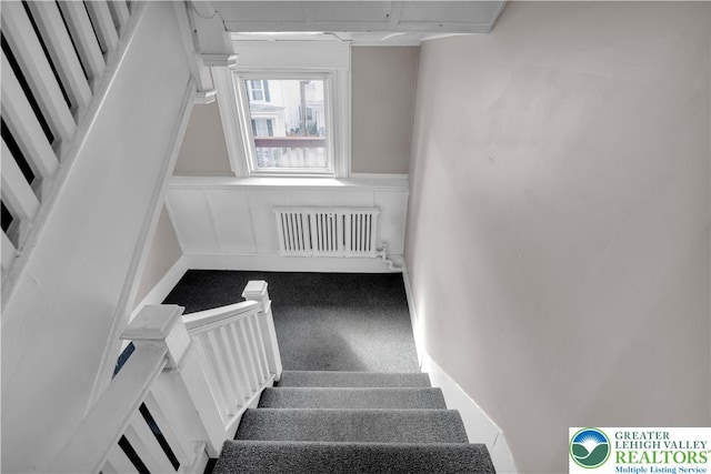 409 Broad St Unit 409, Tamaqua Boro, PA 18252 - staircase featuring radiator heating unit and a wainscoted wall