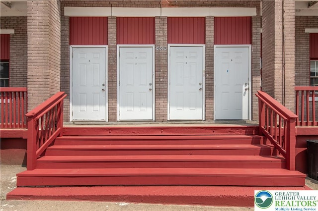 409 Broad St Unit 409, Tamaqua Boro, PA 18252 - doorway to property featuring brick siding, a porch, and board and batten siding
