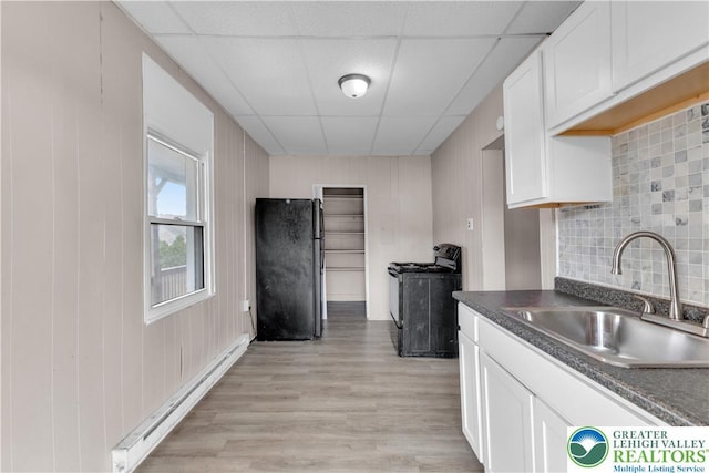 409 Broad St Unit 409, Tamaqua Boro, PA 18252 - kitchen featuring black appliances, baseboard heating, dark countertops, white cabinetry, and a drop ceiling