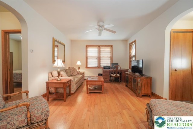 717 Claremont Ave, Schuylkill, PA 18252 - living area featuring arched walkways, a ceiling fan, and light wood-type flooring