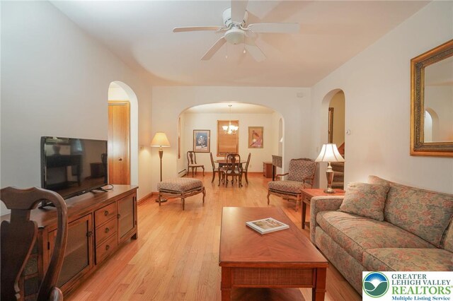 717 Claremont Ave, Schuylkill, PA 18252 - living room with arched walkways, light wood-type flooring, and a ceiling fan
