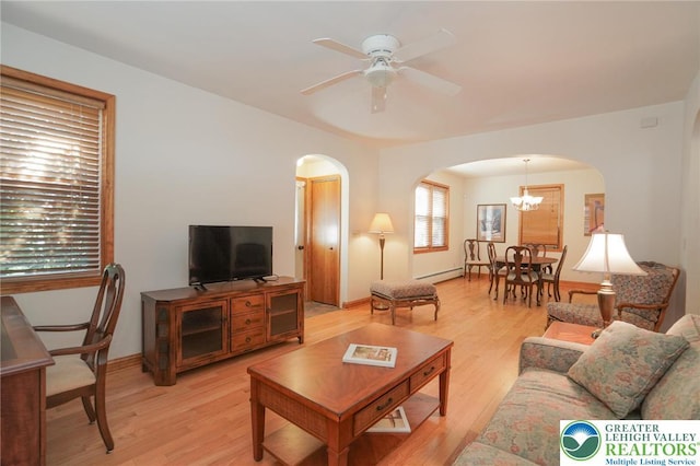 717 Claremont Ave, Schuylkill, PA 18252 - living room with arched walkways, light wood-type flooring, ceiling fan, and a chandelier