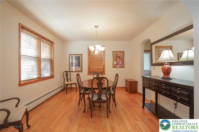 717 Claremont Ave, Schuylkill, PA 18252 - dining room with a baseboard heating unit, arched walkways, light wood-style floors, and a chandelier