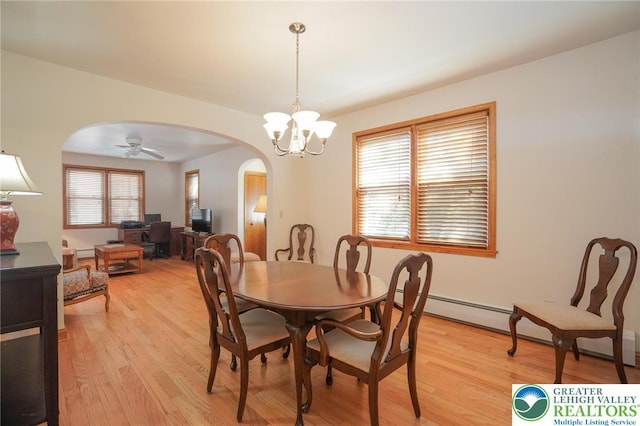 717 Claremont Ave, Schuylkill, PA 18252 - dining room with arched walkways, light wood finished floors, a chandelier, and ceiling fan