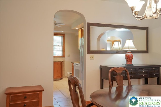 717 Claremont Ave, Schuylkill, PA 18252 - dining room with a chandelier, light tile patterned floors, arched walkways, and ceiling fan