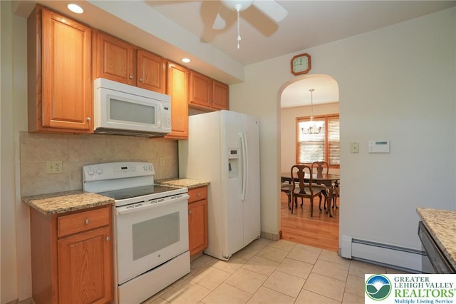 717 Claremont Ave, Schuylkill, PA 18252 - kitchen featuring white appliances, a ceiling fan, baseboard heating, light tile patterned flooring, and arched walkways