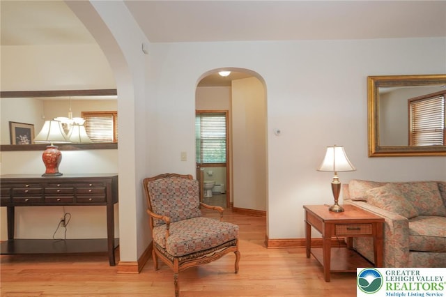 717 Claremont Ave, Schuylkill, PA 18252 - living area with light wood-style floors, a chandelier, and arched walkways